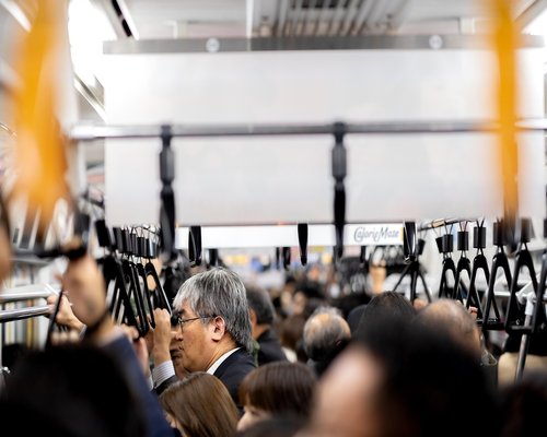 Commuters standing comfortably while riding public transportation